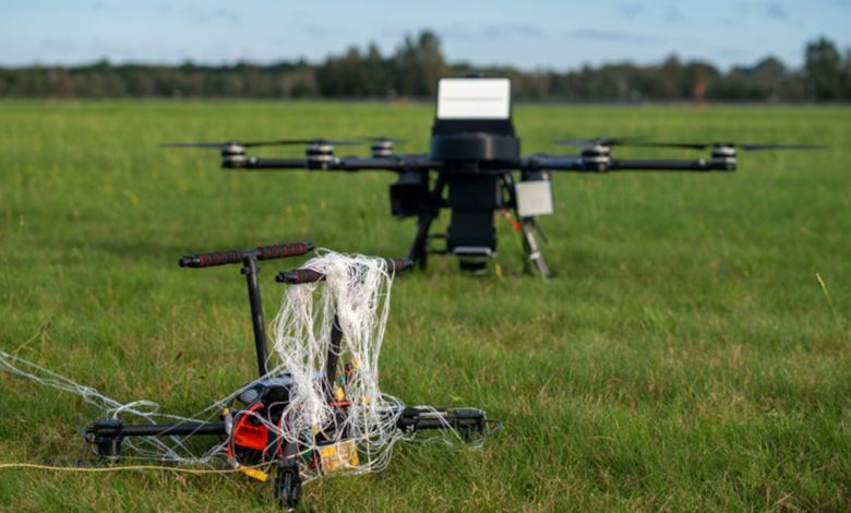UAS drone caught in a net on grass field