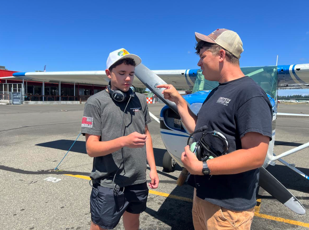two pilots flipping a quarter to decide who is PIC