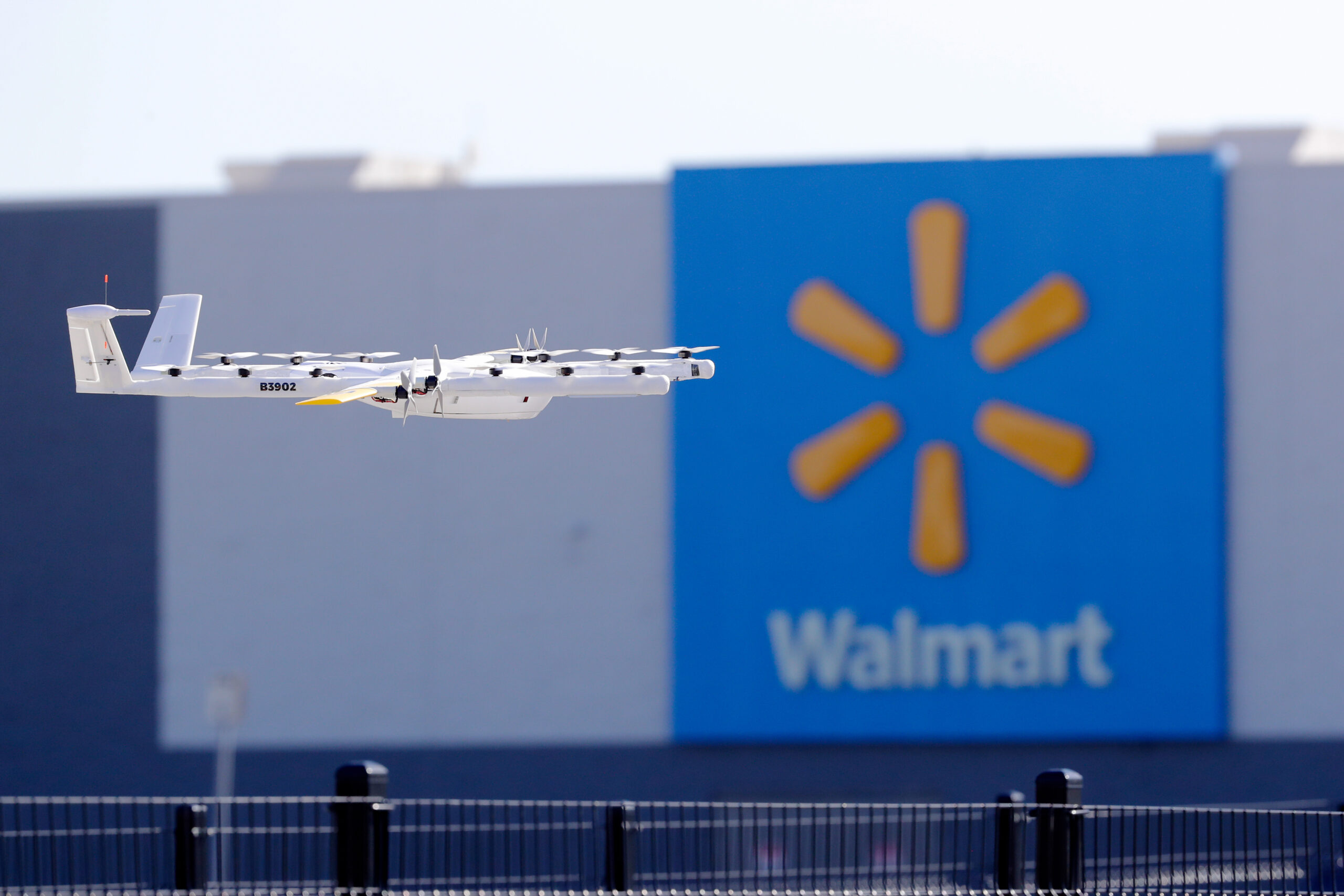 Wing delivery drone flying in front of Walmart store