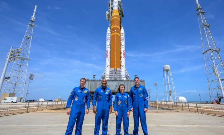 NASA Artemis II moon mission astronauts and SLS rocket at launch pad at Kennedy Space Center in Florida