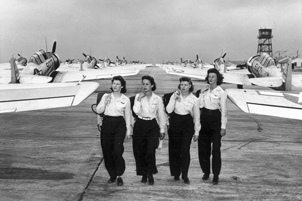 Women Airforce Service Pilots walk among North American AT-6 aircraft at an American base during World War II. [Credit: Public Domain/Museum of Flight]
