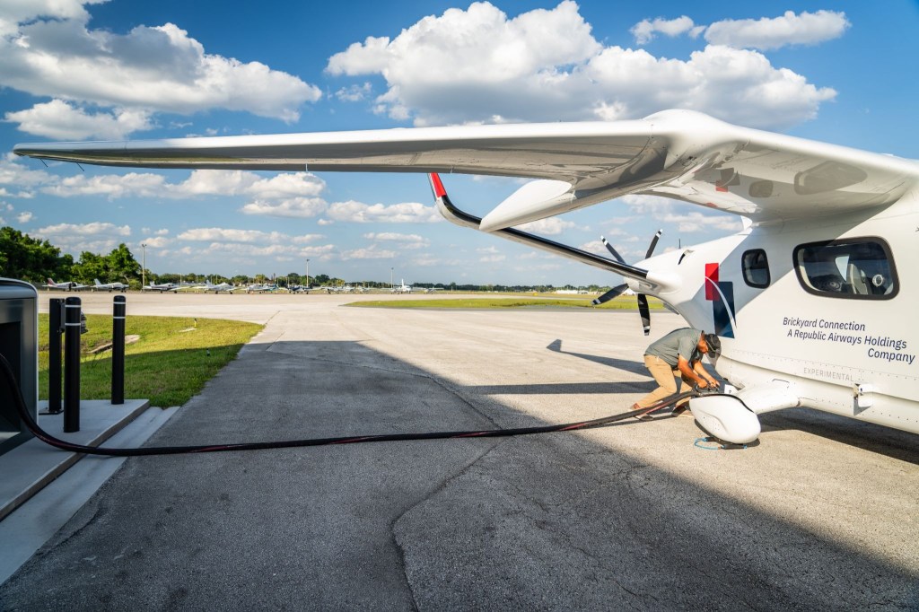 Beta Technologies Alia CX300 electric aircraft charging on runway