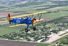 Stearman biplane flying over Stearman Field Airport (1K1) in Benton, Kansas [Credit: Grant Boyd]