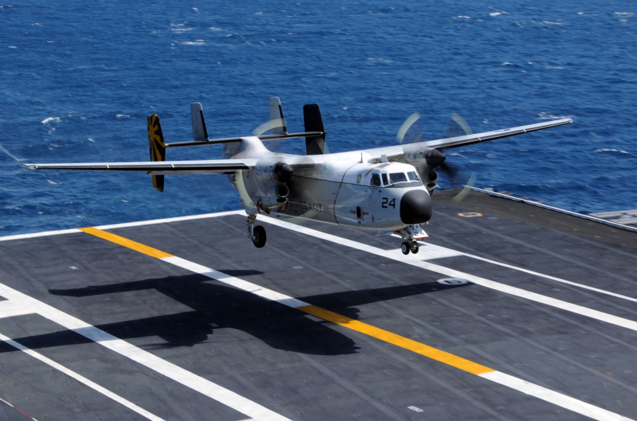 A C-2A Greyhound assigned to the Providers of Fleet Logistics Support Squadron 30 lands aboard the aircraft carrier USS Nimitz. [Credit: U.S. Navy photo by Mass Communication Specialist 3rd Class Peter Merrill]