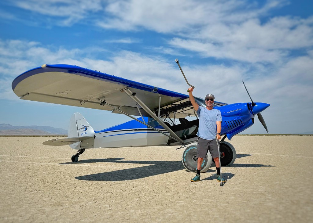 Grant Korgan poses with the Carbon Cub FX-3 he flies all over the Sierra Nevada backcountry. [Credit: Shawn Linch]