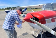 Student pilot examines the prop during preflight check. [Credit: Meg Godlewski]