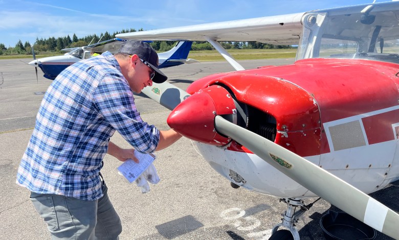 Student pilot examines the prop during preflight check. [Credit: Meg Godlewski]