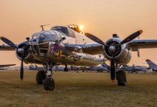A B-25 sits parked against the backdrop of smoke-filled skies at AirVenture in 2024. [Credit: Meg Godlewski]