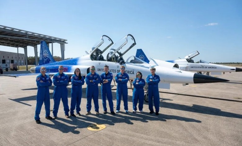 NASA administrator Jared Isaacman and agency personnel stand in front of Isaacman's personal F-5 Tiger II fighter jet