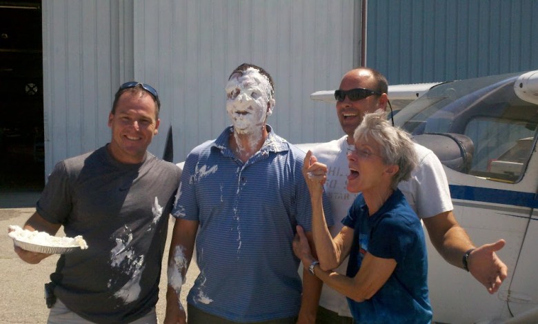 The author (far right) has cut off a few shirttails and plopped a few pies in the faces of first-solo pilots. [Credit: Martha Lunken]