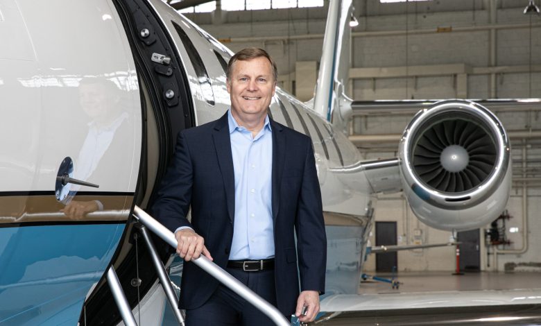 Chris Rocheleau standing in front of business jet