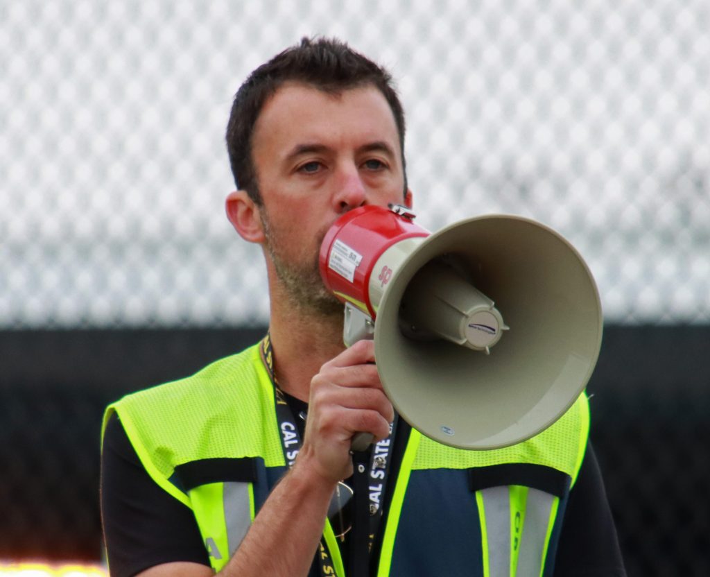 Airport employee Sean Moran delivers instruction to volunteers for the Boeing Field FOD Day 2026. [Credit: King Country International Airport]