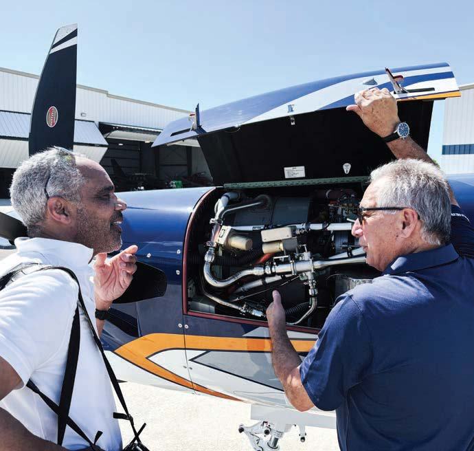 Large access hatches ease preflight inspections, as TBM instructor Paul Salvati demonstrates for the author, Jonathan Welsh. [Credit: Daher Aircraft]