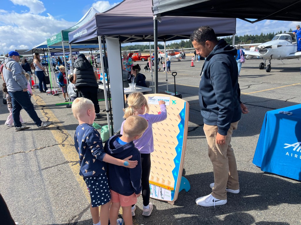 Kids play Plinko at the Alaska Airlines booth at Tacoma Narrows’ Airport Day in Washington state. [Credit: Meg Godlewski]