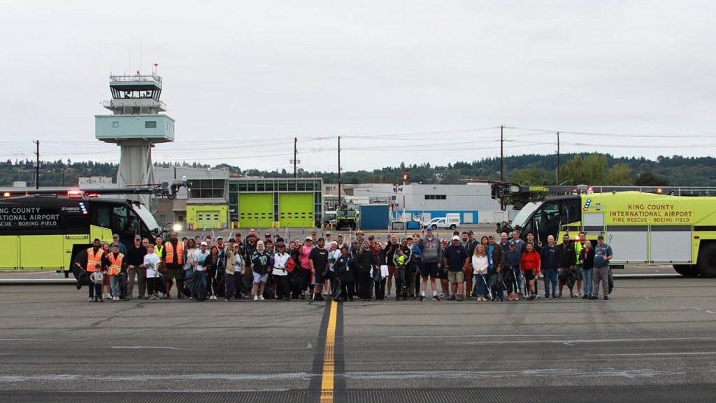 Volunteers pose for a team photo after Boeing Field FOD Day 2026. [Credit: King County International Airport]