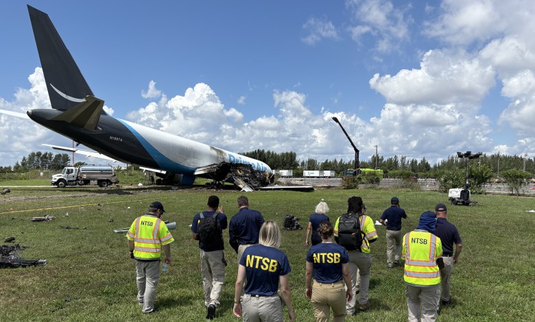 NTSB personnel approach Amazon Prime Air 21 Air Boeing 767-33A cargo jet wreckage at Miami International Airport