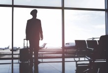 Silhouette of pilot standing in airport terminal