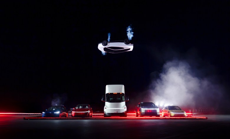 Tesla flying Roadster inverted over a row of other vehicles