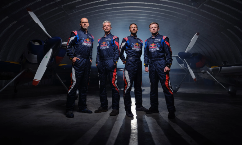 Red Bull Aerobatic Team pilots posing in front of XA42 XtremeAir aircraft