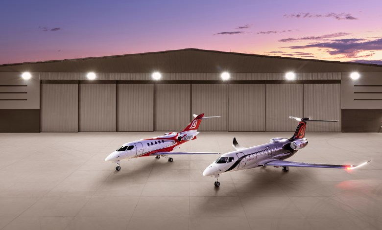 SyberJet SJ34 and SJ36 business jets in front of hangar