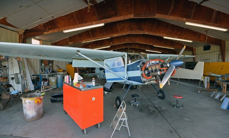 Single engine airplane undergoing an inspection in a hangar