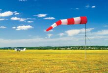 A red and white windsock. [Adobe Stock]