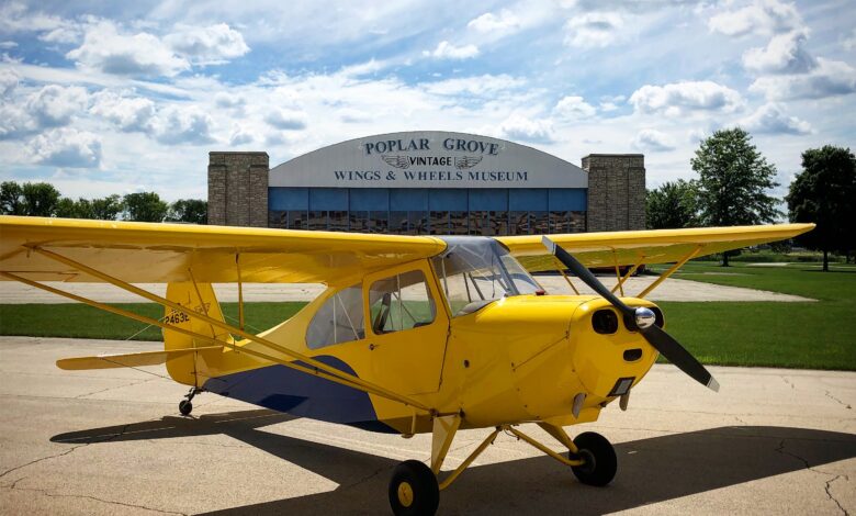 Yellow vintage airplane at Poplar Grove Wings & Wheels Museum.