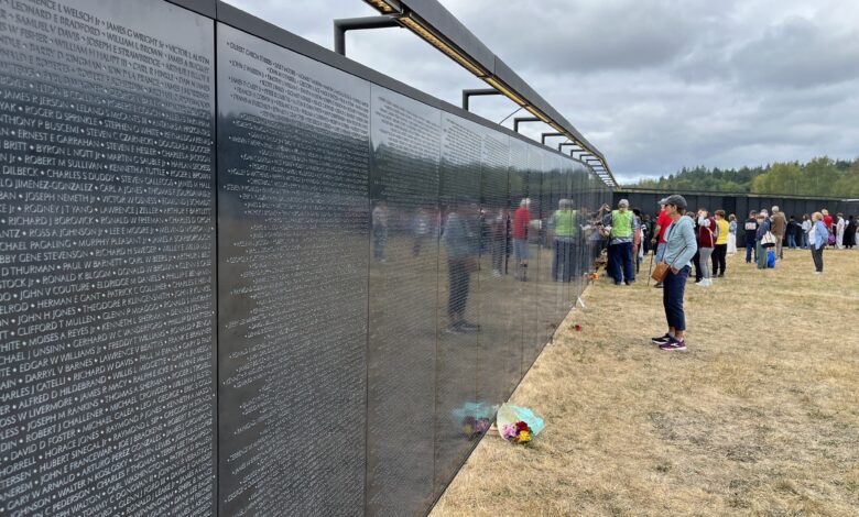 Visitors pay their respects at the traveling Vietnam Veterans Memorial wall, which made a tour stop at Jefferson County Airport in Washington state. [Courtesy: Meg Godlewski]