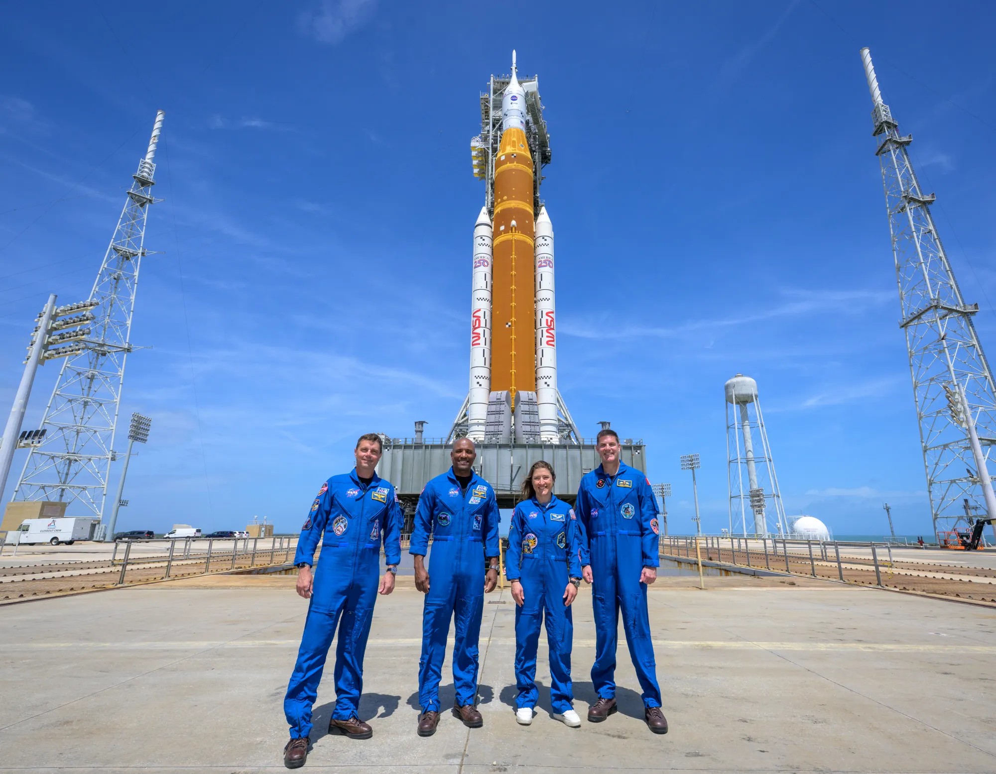 NASA Artemis II moon mission astronauts and SLS rocket at launch pad at Kennedy Space Center in Florida