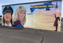A mural to honor influential women aviators (Kimberly Scott Ford, left, and Joann Osterud) goes up at Auburn Municipal Airport near Seattle. [Credit: Meg Godlewski]
