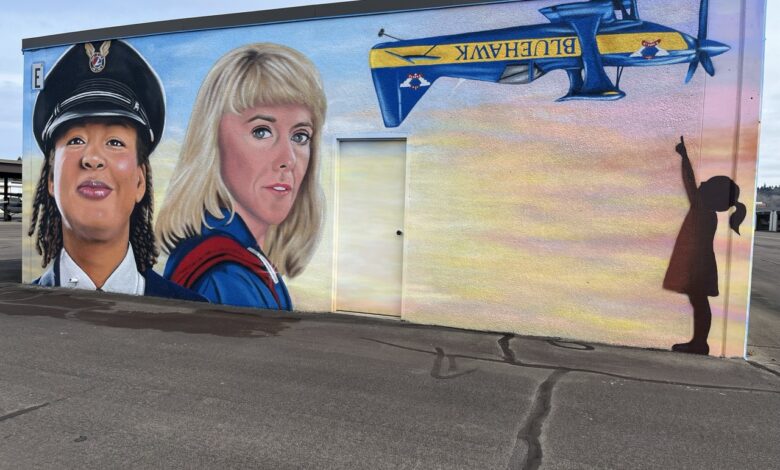 A mural to honor influential women aviators (Kimberly Scott Ford, left, and Joann Osterud) goes up at Auburn Municipal Airport near Seattle. [Credit: Meg Godlewski]